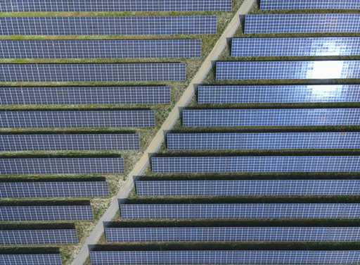 The sun reflected in solar panels of the EnBW solar park at Gottesgabe, Germany, Friday, July 1, 20…