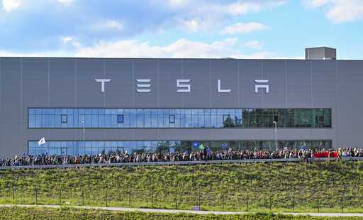 Demonstrators walk past the Tesla factory in Gruenheide, Germany, May 11, 2024, at the end of their…