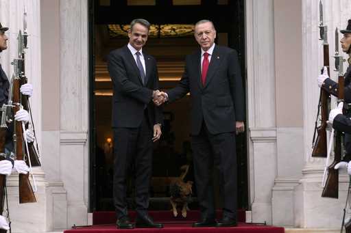 Greece's Prime Minister Kyriakos Mitsotakis, left, welcomes the Turkey's President Recep Tayyip Erd…