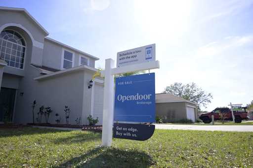 File - Real estate signs are posted outside homes for sale, Tuesday, February 21, 2023, in Valrico,…