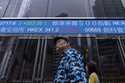 A pedestrian passes by the Hong Kong Stock Exchange electronic screen in Hong Kong, Thursday, March…