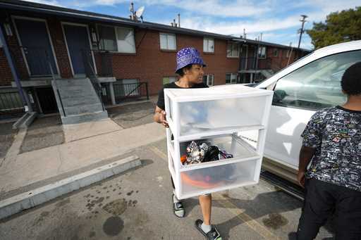 Monique Gant moves belongings out of an apartment after being evicted, Wednesday, January 31, 2024,…