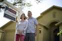 Scott and Sheila Collett stand in front of the home that they recently purchased, Tuesday, February…