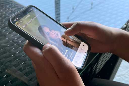 Teenager Shreya Nallamothu looks at her phone in Bloomington, Ill