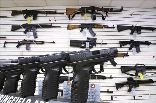 Semi-automatic guns are displayed for sale at Capitol City Arms Supply, January 16, 2013, in Spring…