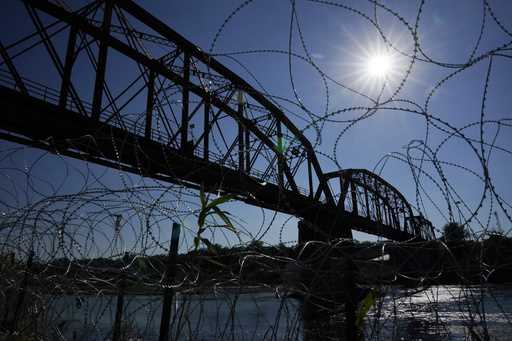 The Union Pacific International Railroad Bridge is seen behind concertina wire, Sept
