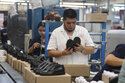 People work in a shoe maquiladora or factory in Leon, Mexico, Monday, February 7, 2023