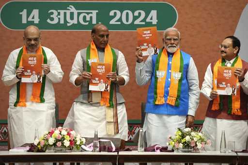 Indian Prime Minister Narendra Modi, second right, releases his ruling Bharatiya Janata Party's man…