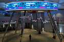 A man walks past an electronic board displaying stock prices and Jakarta Stock Exchange Composite I…