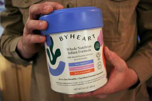 Stephen Dexter holds a container of ByHeart baby formula, which was recently recalled by ByHeart, i…
