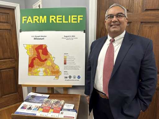 Missouri Treasurer Vivek Malek stands near a poster promoting drought conditions and state aid prog…