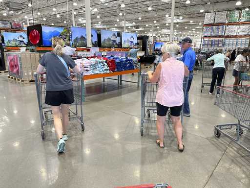 Shoppers push carts into a Costco warehouse Friday, August 4, 2023, in Thornton, Colo