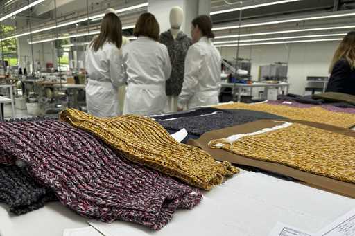 Knitwear created by Italian artisans for the Prada and Miu Miu brands sit on a desk at a recently e…