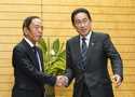 New Governor of the Bank of Japan Kazuo Ueda, left, meets Japanese Prime Minister Fumio Kishida at …