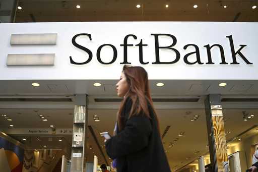 A woman walks past a SoftBank store in the Ginza shopping district in Tokyo on January 20, 2020