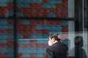 A person looks at an electronic stock board showing Japan's stock princes at a securities firm Tues…