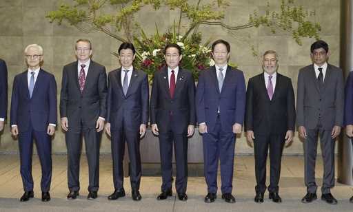 Japanese Prime Minister Fumio Kishida, center, and Economy Minister Yasutoshi Nishimura, center rig…