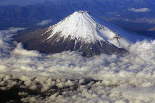 In this December 8, 2010 file photo, snow-covered Mount Fuji, Japan's highest peak at 3,776-meters …