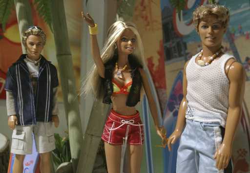 File - Barbie is shown next to her longtime boyfriend, Ken, right, and her new admirer Blaine, an A…
