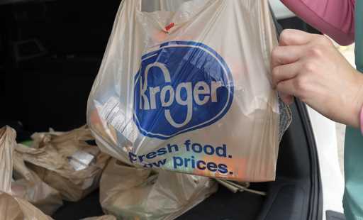 A customer removes her purchases at a Kroger grocery store in Flowood, Miss