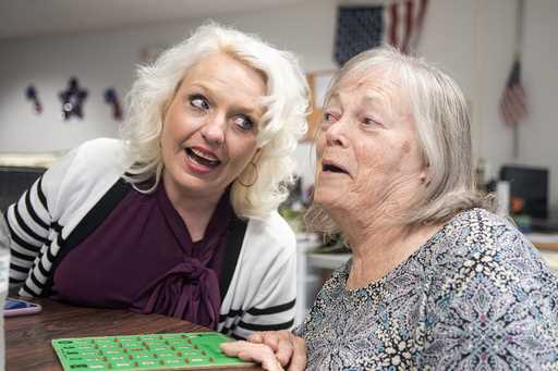 VNA Caring Center Director Angela Loeper, left, sings an oldies tune with client Marilyn Vargo of M…