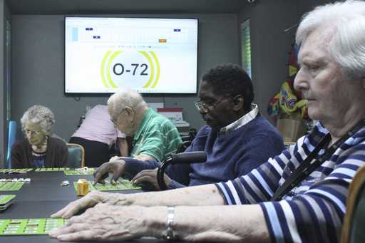Eberline Nugent, left, Johnny Griffin, Jay Cossey and Carrie Dickson play bingo during activity tim…