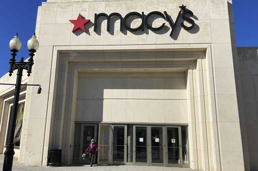 A shopper exits Macy's at the Woodfield Old Orchard Shopping Center in Skokie, Ill