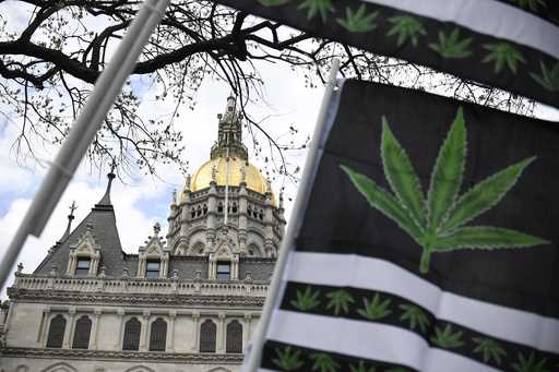 Flags with a marijuana leaf wave outside the Connecticut State Capitol building, April 20, 2021, in…
