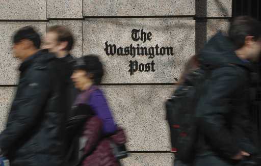 People walk by the One Franklin Square Building, home of The Washington Post newspaper, in downtown…