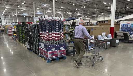 A shopper moves past a display of items in a Costco warehouse Saturday, May 18, 2024, in Sheridan, …