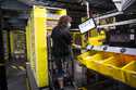 Marie Steele works as a picker at an Amazon fulfillment center on October 8, 2020, in Shakopee, Min…