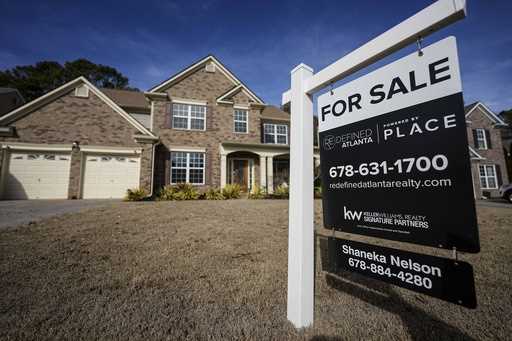 A sign announcing a home for sale is posted outside a home, Thursday, February 1, 2024, in Aceworth…