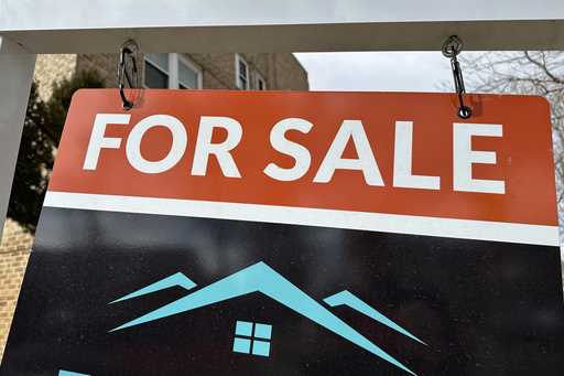 A sale sign stands outside a condominium on the market Wednesday, February 21, 2024, in Denver