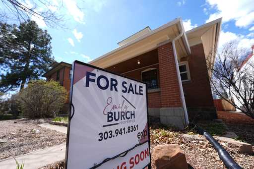 A for sale sign stands outside a home on the market Wednesday, April 3, 2024, in Denver