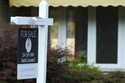 A "For Sale" sign is displayed in front of a home in Des Plaines, Ill