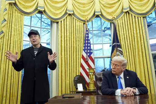 President Donald Trump listens as Elon Musk speaks in the Oval Office at the White House, February …