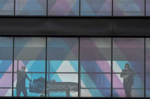 Health care workers are seen from an overpass at Mount Sinai Hospital, Tuesday, March 16, 2021, in …