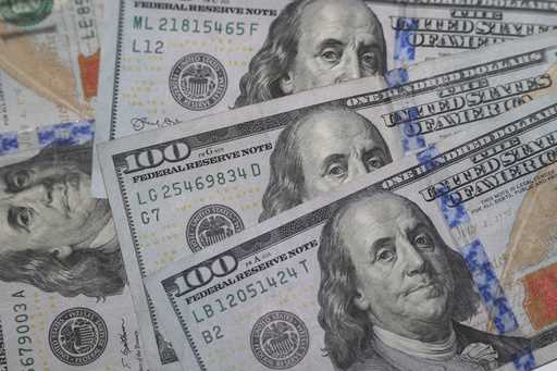 This January 22, 2020, file photo shows the likeness of Benjamin Franklin on $100 bills in Dallas