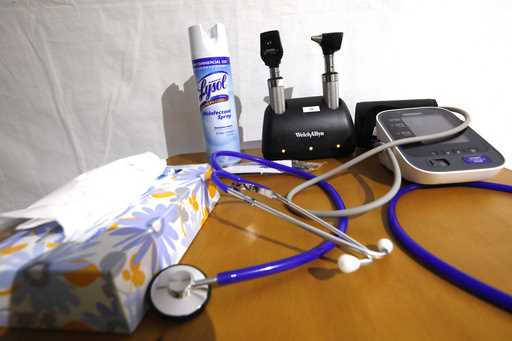 A stethoscopes and blood pressure monitor on set on a rolling rolling table at the University of Mi…