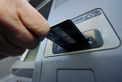 In this Saturday, January 5, 2013 file photo, a person inserts a debit card into an ATM in Pittsbur…