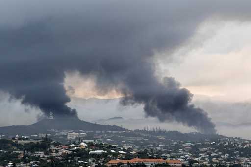 Smoke rises during protests in Noumea, New Caledonia, on May 15, 2024