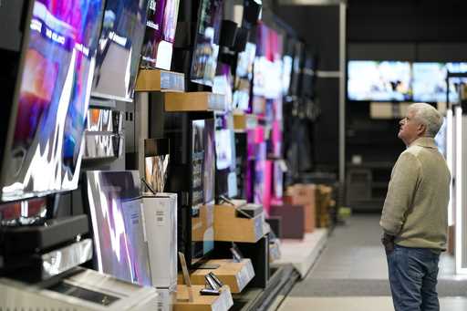 A customer browses televisions at a Best Buy store on Black Friday, Friday, November 24, 2023, in C…
