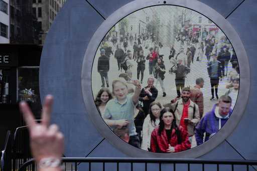 People in both New York and Dublin, Ireland, wave and signal at each other while looking at a lives…