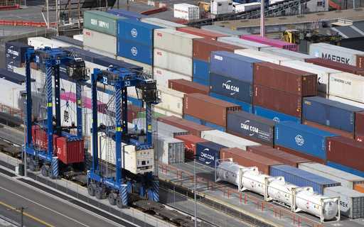 Shipping containers are moved at the Port of Lyttelton near Christchurch, New Zealand, on Sept