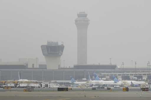 Fog covers planes and control towers at Newark Liberty International Airport in Newark, N