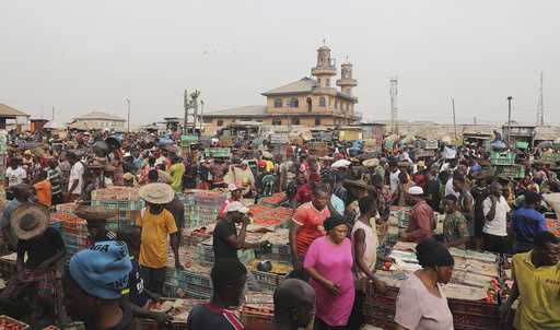 Pedestrian shop for food at the Mile 12 Market in Lagos, Nigeria, Friday, February 16, 2024