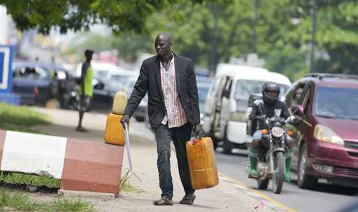 A man sells black market fuel on the street in Lagos, Nigeria, Tuesday, May 30, 2023