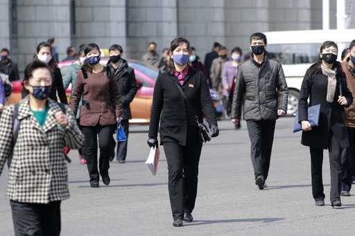 Pedestrians wear face masks to help prevent the spread of the new coronavirus in Pyongyang, North K…
