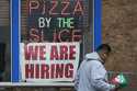 A hiring sign is displayed at a restaurant in Prospect Heights, Ill