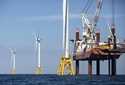 FILE — A lift boat, right, that serves as a work platform, assembles a wind turbine on August 15, 2…